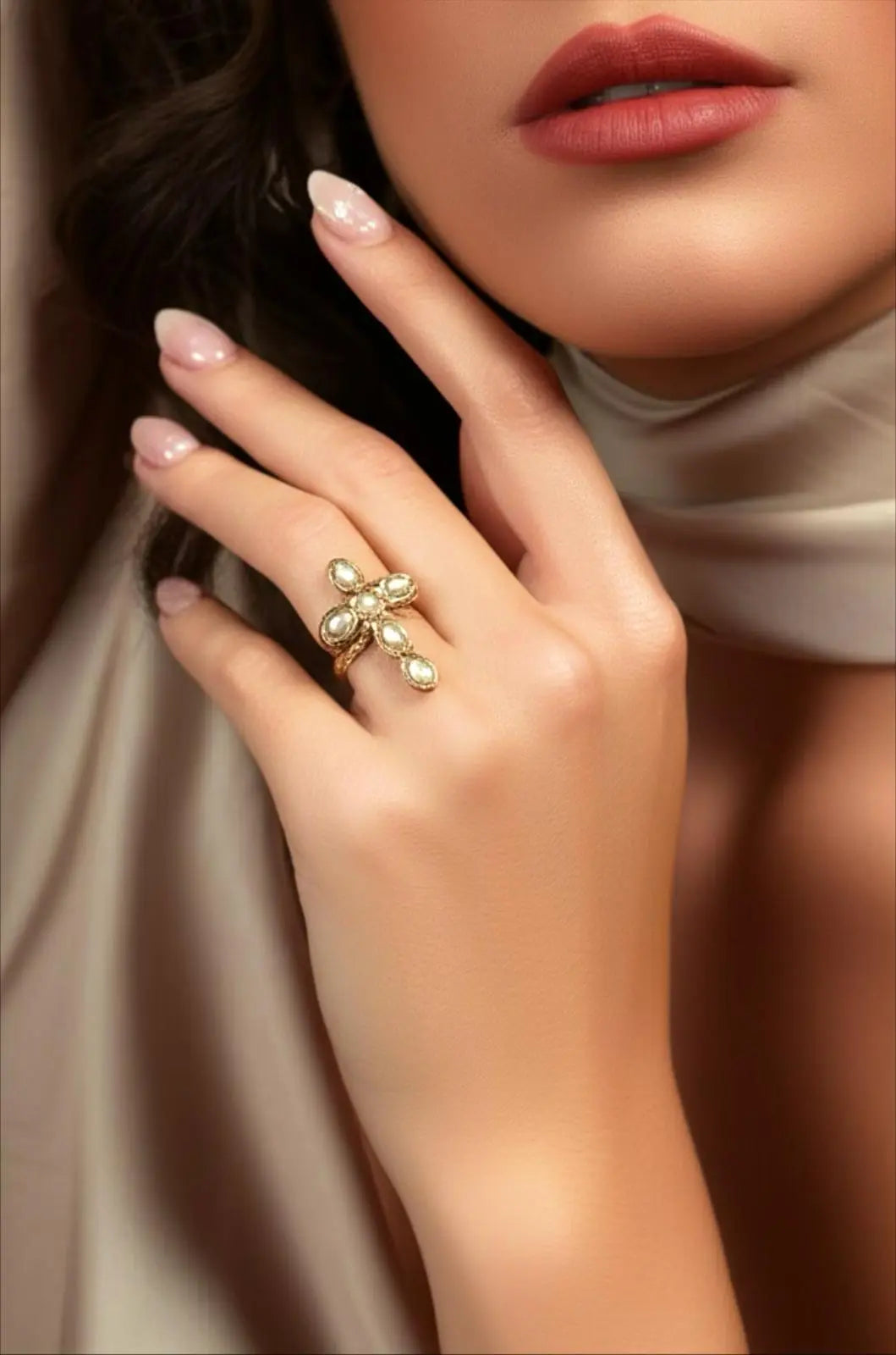 Bague dorée croix perles acier inoxydable femme portée sur la main avec maquillage naturel