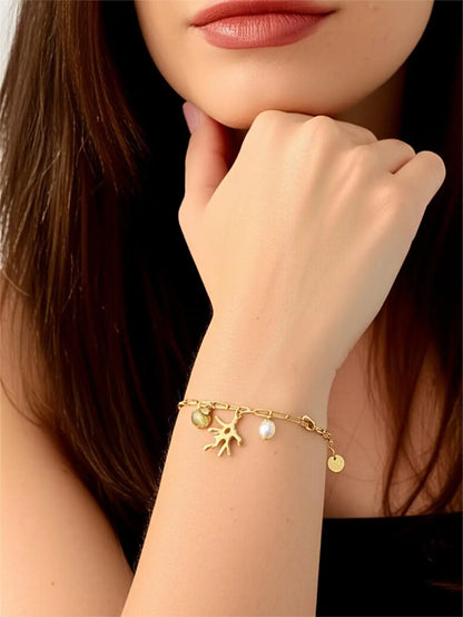 Bracelet fantaisie perle et coquillage acier inoxydable femme doré porté au poignet
