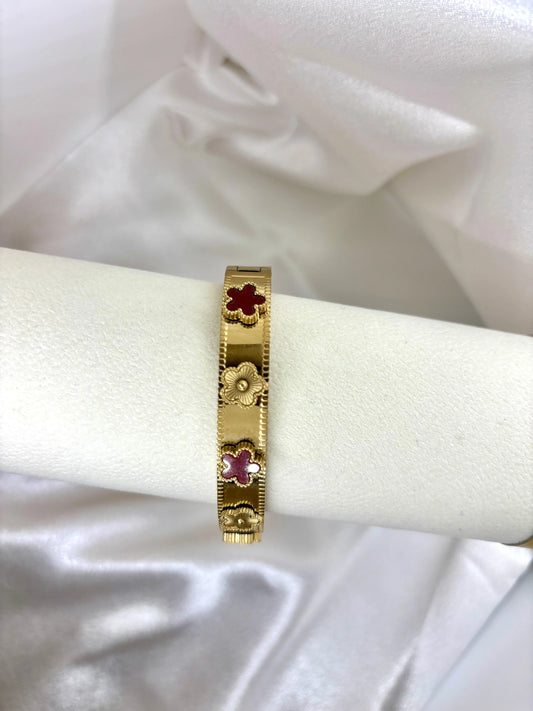 Bracelet jonc doré fleurs colorées acier inoxydable femme similaire louis vitton présenté sur support blanc