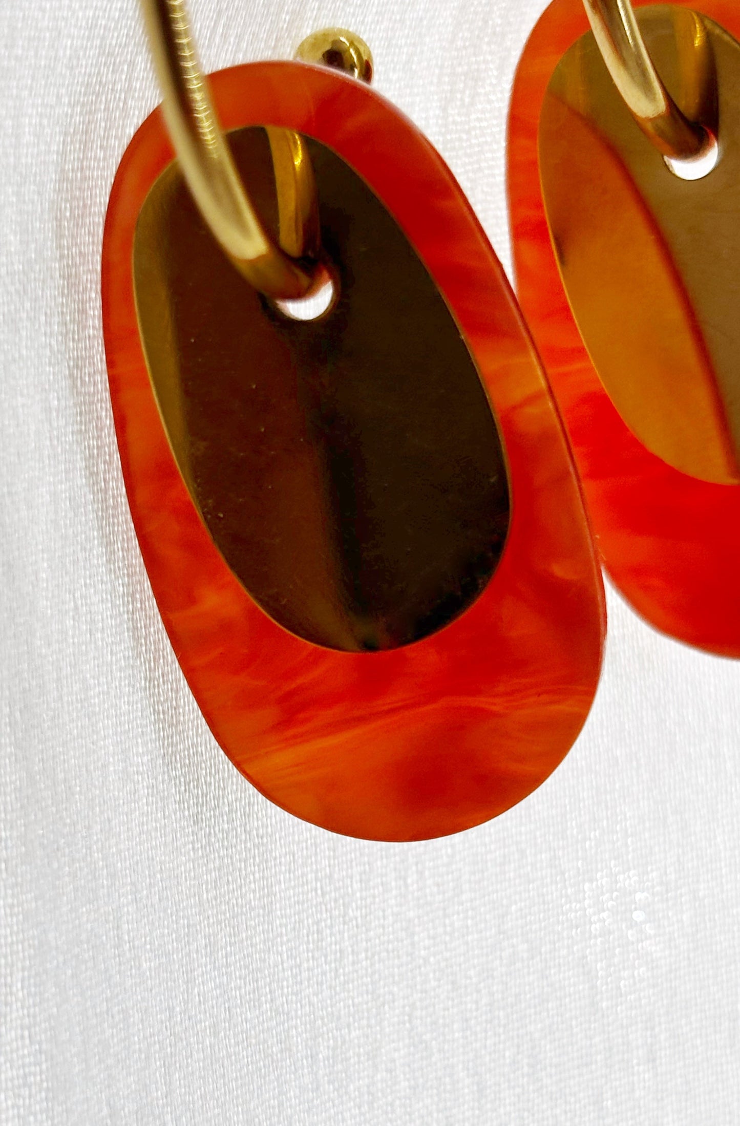 Créoles orange doré acier inoxydable femme avec design ovale et finition brillante